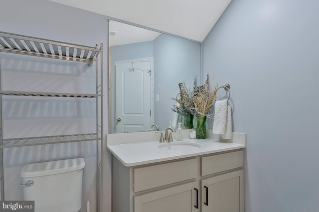 bathroom featuring vanity and toilet