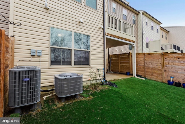 exterior space featuring a lawn and central air condition unit