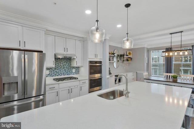 kitchen with stainless steel appliances, hanging light fixtures, sink, and white cabinets