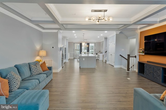 living room with beamed ceiling, hardwood / wood-style flooring, ornamental molding, coffered ceiling, and an inviting chandelier