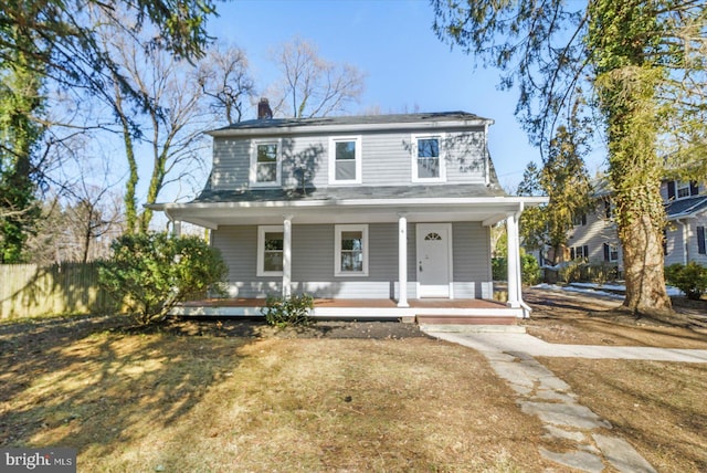 view of front of home with a porch and a front yard