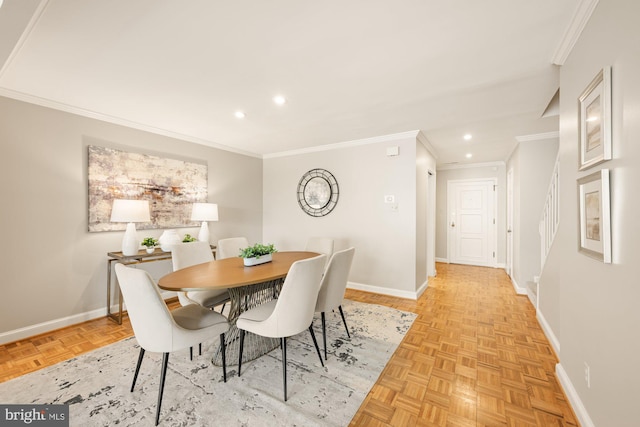 dining room with ornamental molding and light parquet flooring