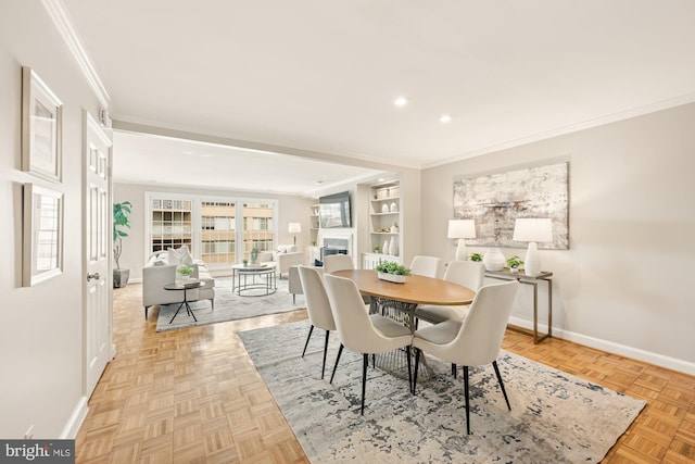 dining space with ornamental molding and light parquet floors