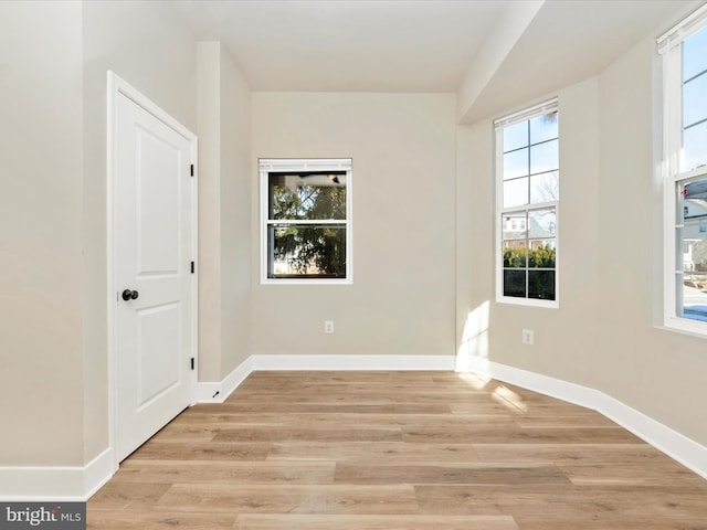 spare room with light hardwood / wood-style floors