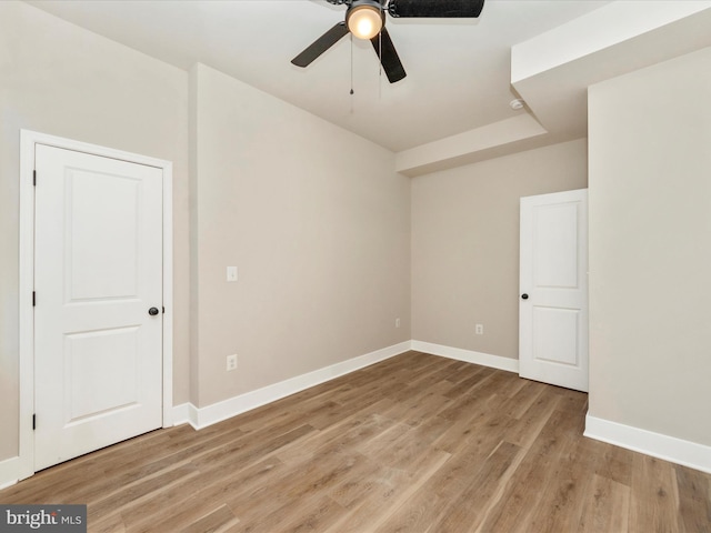 empty room with light hardwood / wood-style flooring and ceiling fan