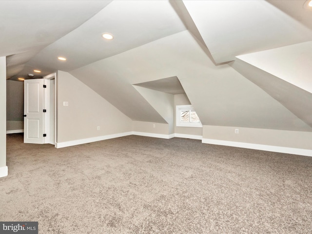 bonus room with lofted ceiling and carpet