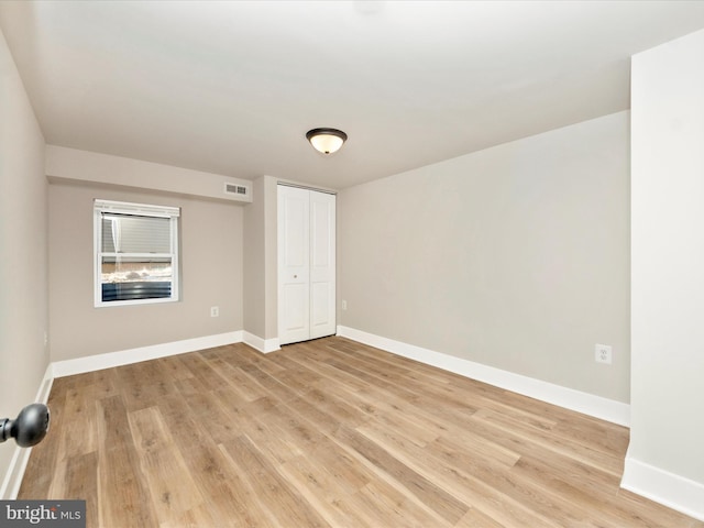 spare room featuring light hardwood / wood-style flooring