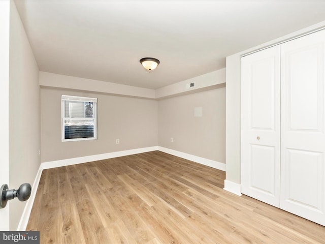 unfurnished bedroom featuring a closet and light hardwood / wood-style flooring