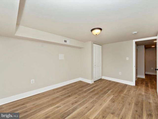 basement with hardwood / wood-style flooring