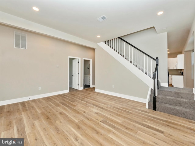 unfurnished living room with light hardwood / wood-style flooring