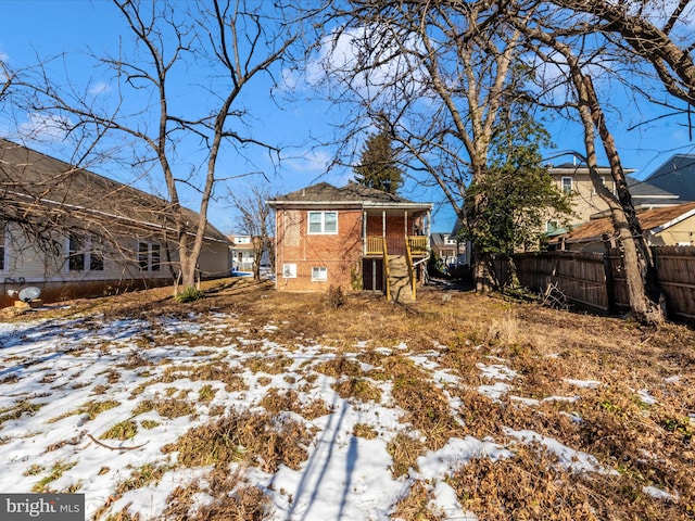 view of snow covered rear of property