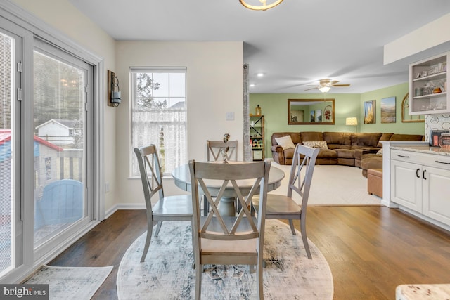 dining area featuring dark hardwood / wood-style flooring and ceiling fan