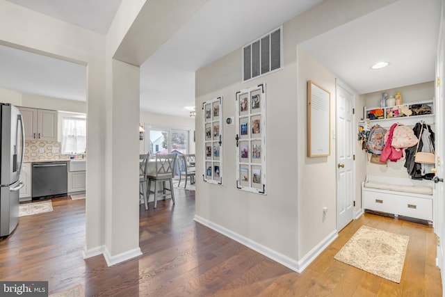 hall with hardwood / wood-style flooring