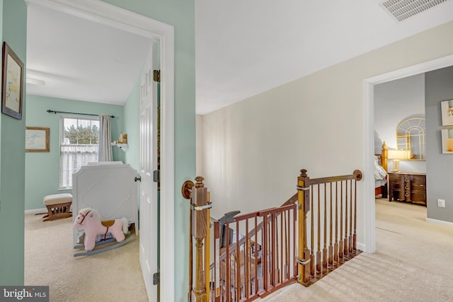 corridor featuring light colored carpet