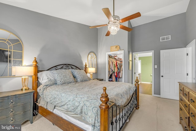 bedroom featuring a spacious closet, light colored carpet, high vaulted ceiling, a closet, and ceiling fan