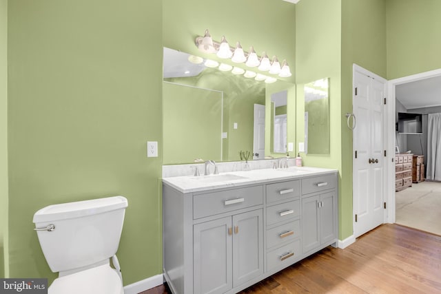 bathroom featuring hardwood / wood-style flooring, vanity, and toilet