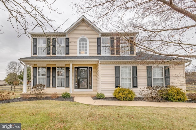 view of front of home with a front lawn and a porch