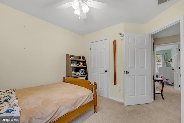 bedroom with light carpet and ceiling fan