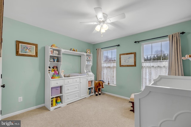 bedroom featuring light colored carpet and ceiling fan