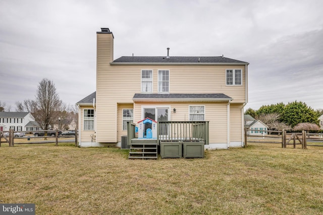 back of property with a yard, a deck, and central air condition unit