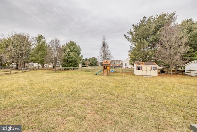 view of yard featuring a shed and a playground