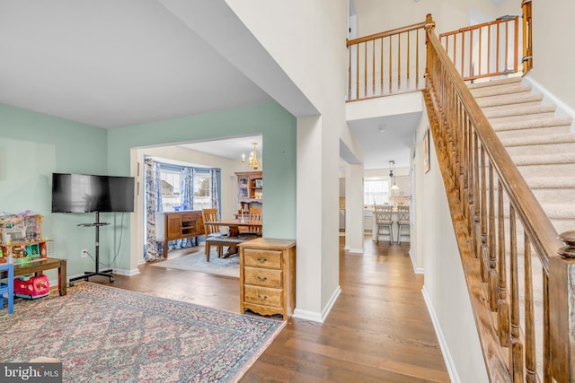 entryway featuring hardwood / wood-style flooring, a wealth of natural light, and an inviting chandelier