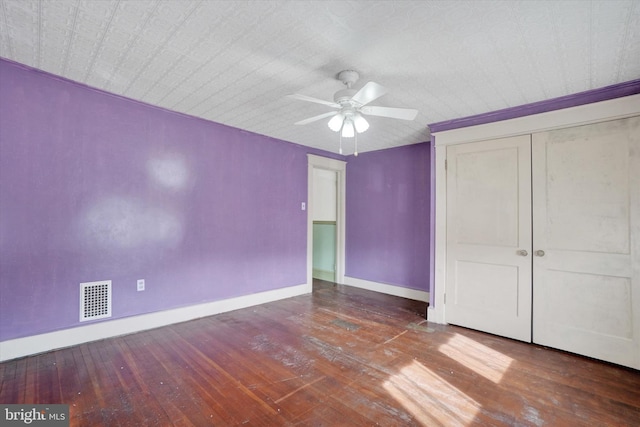 unfurnished bedroom featuring hardwood / wood-style floors, ceiling fan, and a closet