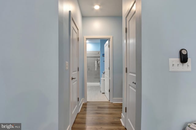 corridor with wood-type flooring