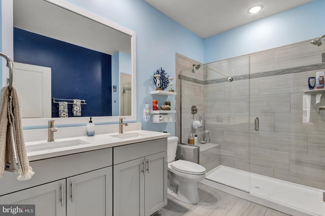 bathroom featuring vanity, toilet, and walk in shower