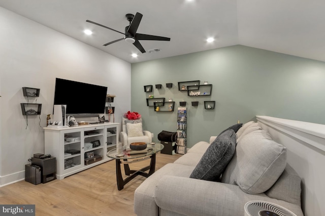 living room featuring lofted ceiling, ceiling fan, and light wood-type flooring