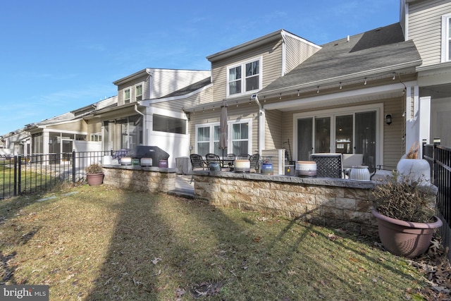 back of property featuring a lawn and a patio area