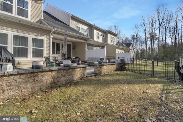 rear view of house featuring a yard and a patio area