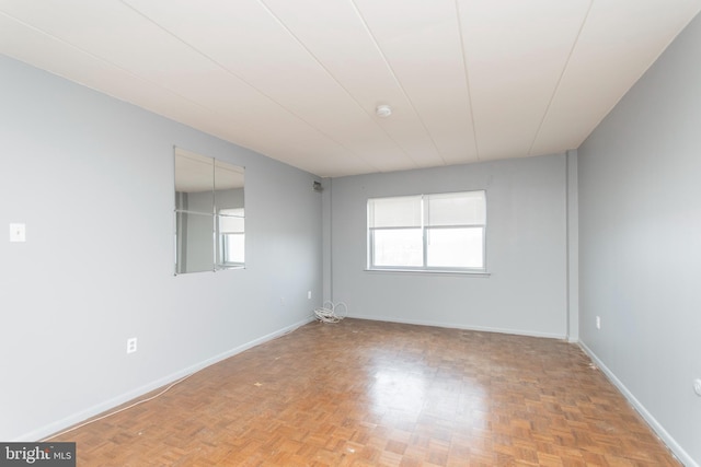 unfurnished room featuring a healthy amount of sunlight and light parquet flooring