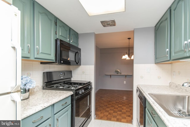 kitchen featuring sink, backsplash, black appliances, and hanging light fixtures