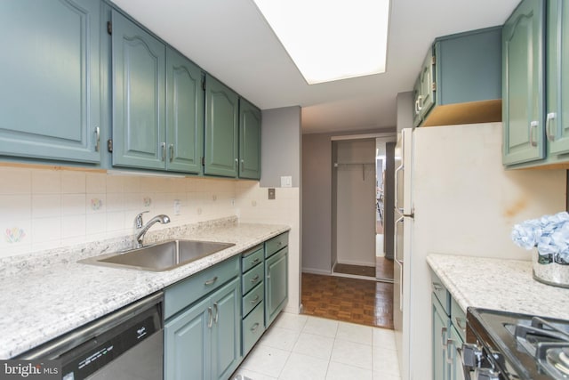 kitchen with light tile patterned flooring, tasteful backsplash, dishwasher, sink, and stove