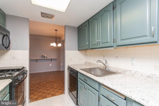 kitchen featuring pendant lighting, sink, decorative backsplash, light parquet floors, and black appliances