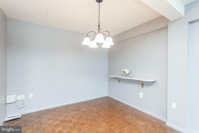 empty room featuring parquet floors and a chandelier