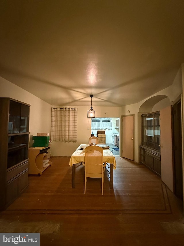 dining area featuring lofted ceiling and hardwood / wood-style floors