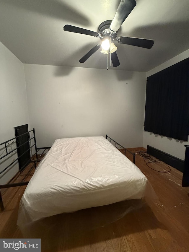 bedroom with ceiling fan and dark hardwood / wood-style floors