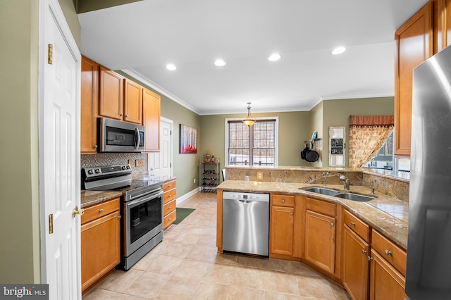 kitchen featuring sink, crown molding, decorative light fixtures, appliances with stainless steel finishes, and backsplash