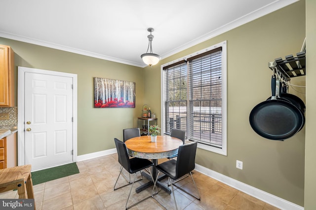 dining room featuring crown molding and light tile patterned flooring