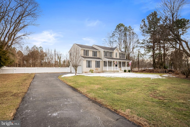 view of front of property with covered porch and a front lawn