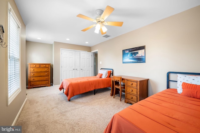 carpeted bedroom with a closet and ceiling fan