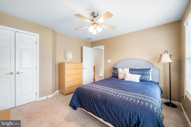 carpeted bedroom with a closet and ceiling fan