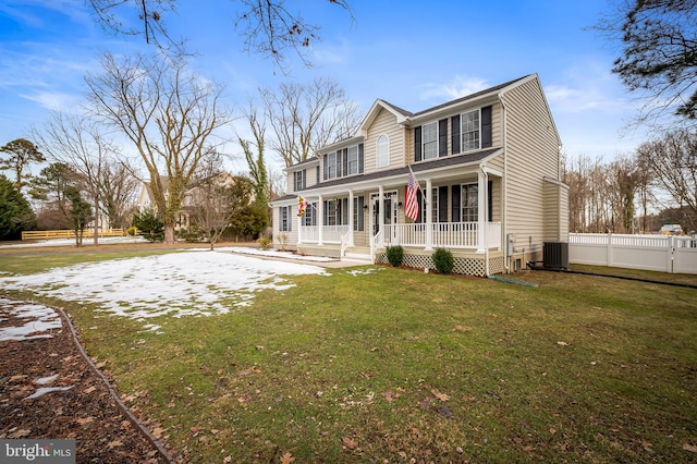 view of front facade featuring central AC, a front lawn, and covered porch