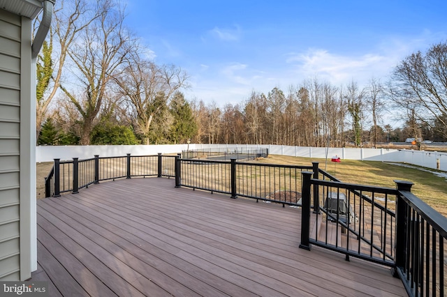 wooden terrace featuring a yard