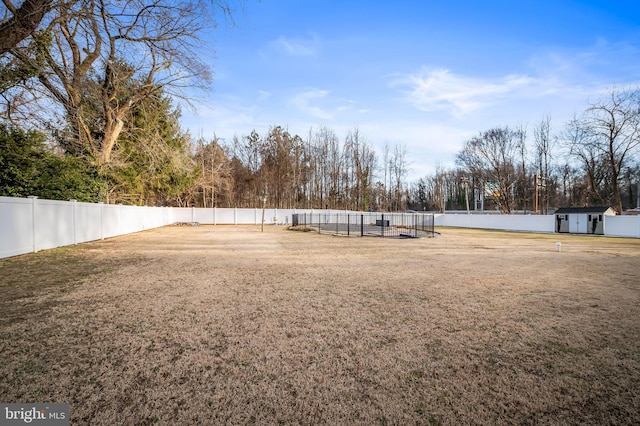 view of yard with a swimming pool and a storage shed