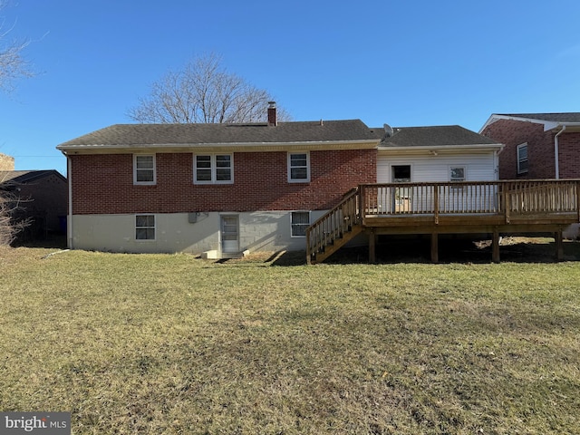 back of house featuring a wooden deck and a yard