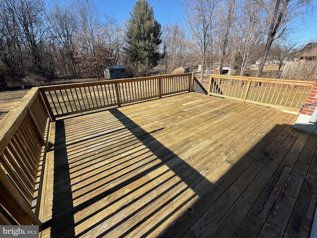 wooden deck featuring a storage unit