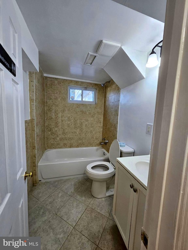 full bathroom with tile patterned floors, vanity, toilet, and tiled shower / bath combo